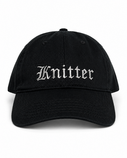 Black cap with 'Knitter' embroidered on a white background