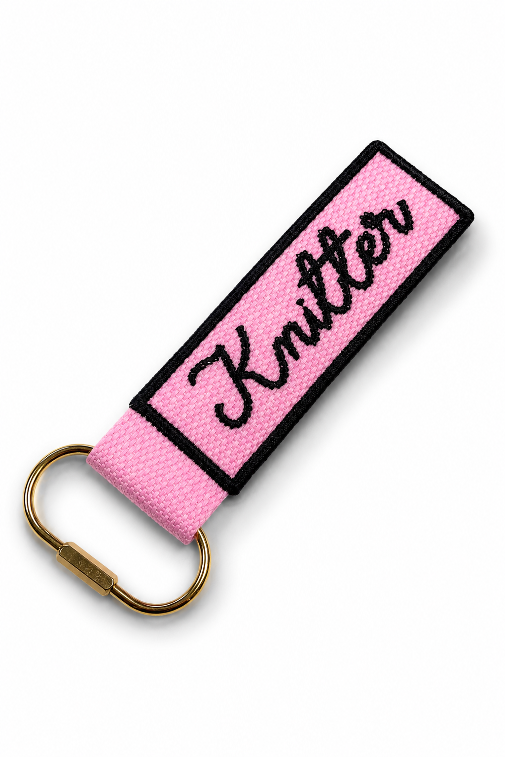 Pink keychain with 'Knitter' text on a white background