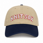 Khaki and navy split crown hat with red Knit Sox embroidery and white puff embroidery