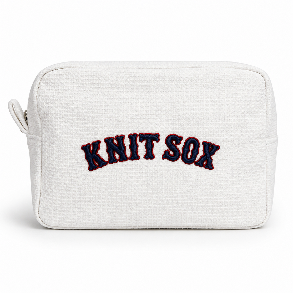 White zip pouch with red Knit Sox embroidery and navy 3D puff detail
