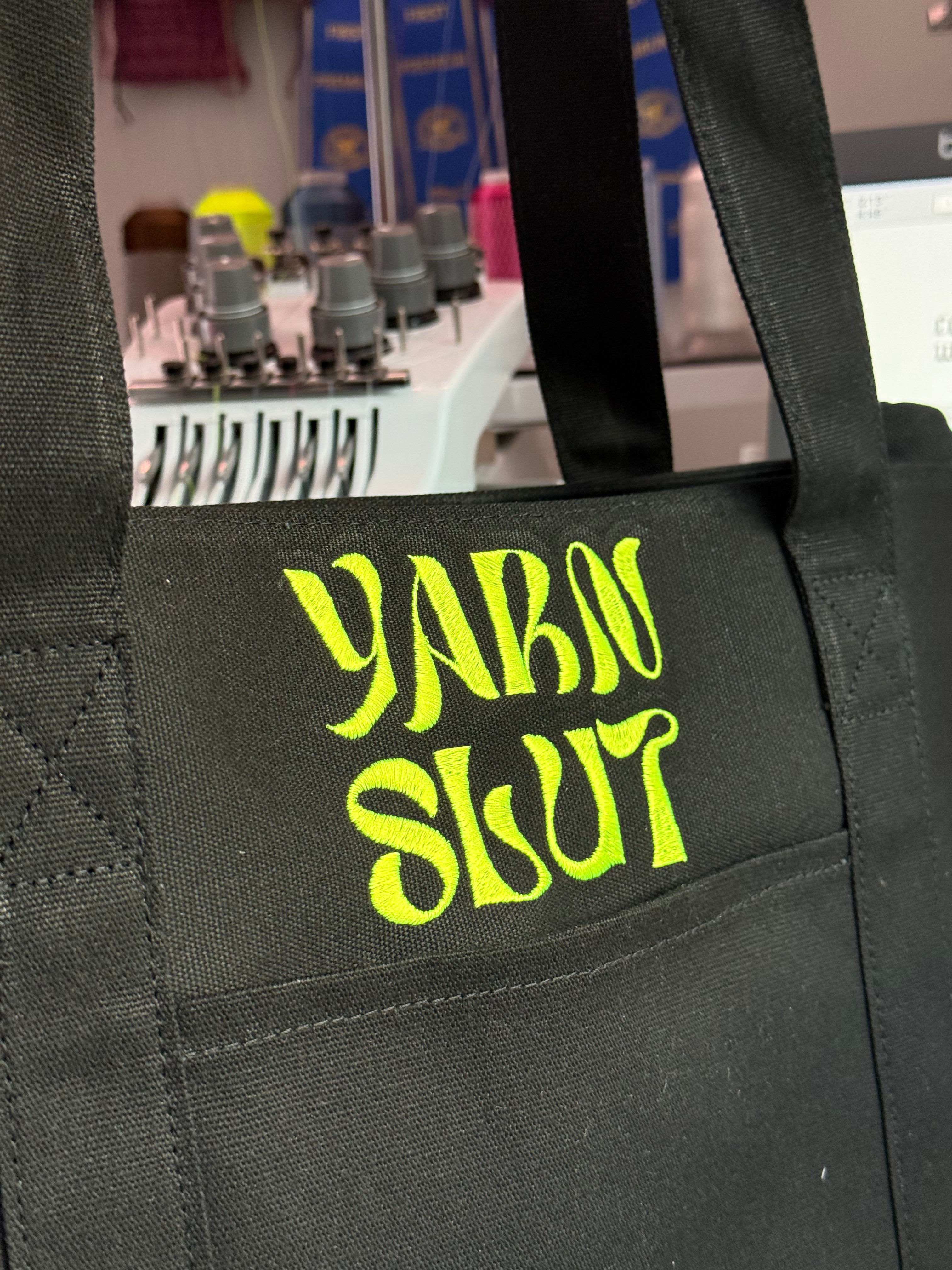 Yarn Slut Black Stash Tote with neon green groove embroidery