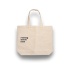 Beige tote bag with 'resting stitch face' text on a white background
