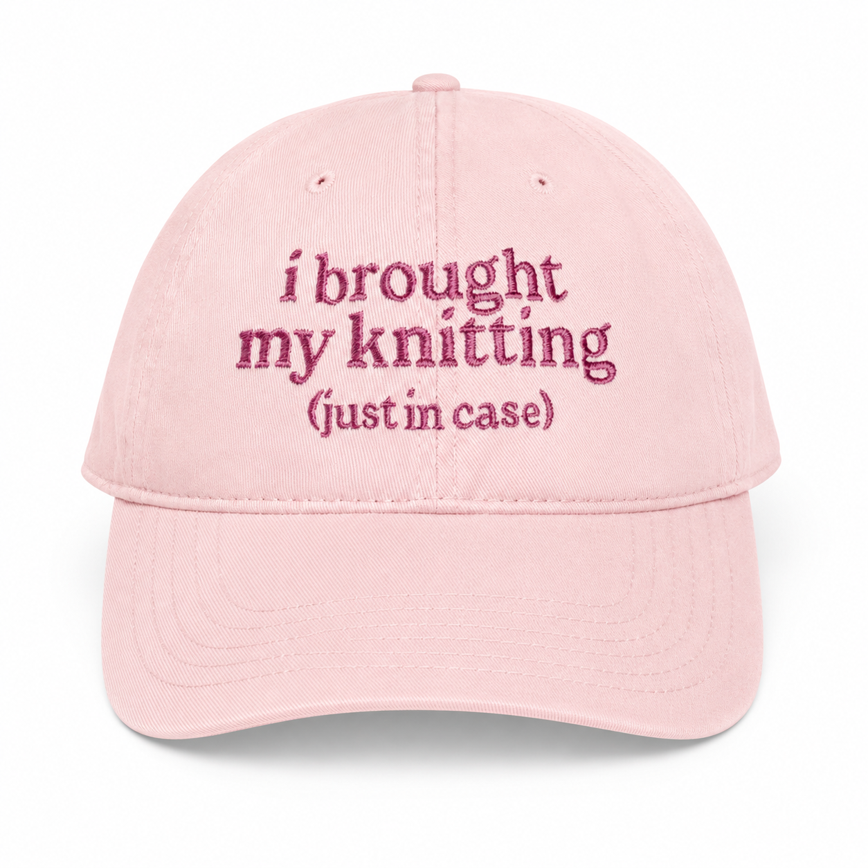 Pink cap with embroidered text on a white background
