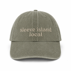 Green cap with 'sleeve island local' text on a white background