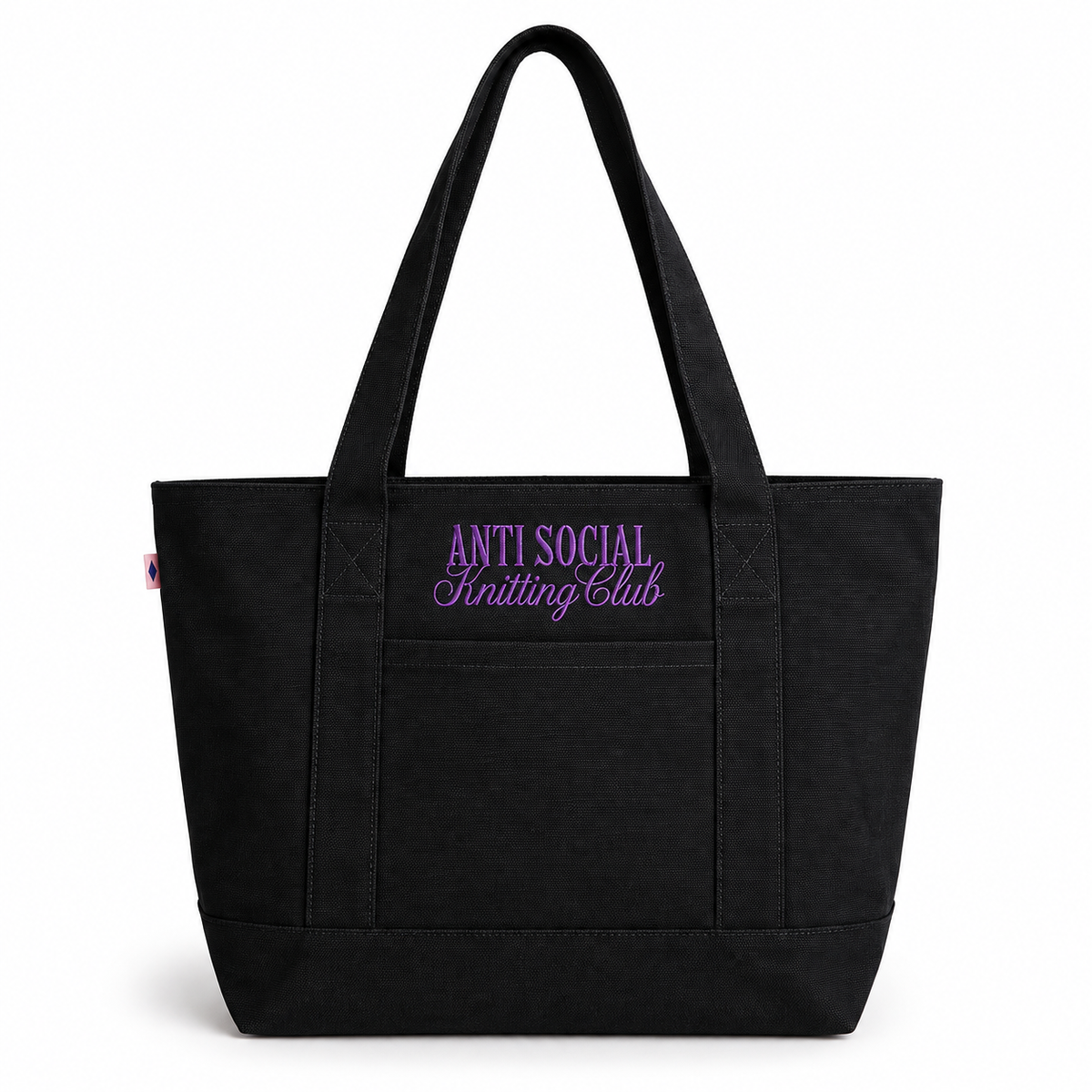 A black canvas tote bag with dual shoulder straps, featuring purple embroidered text on the front pocket that reads 'ANTI SOCIAL Knitting Club' on a clean white background.