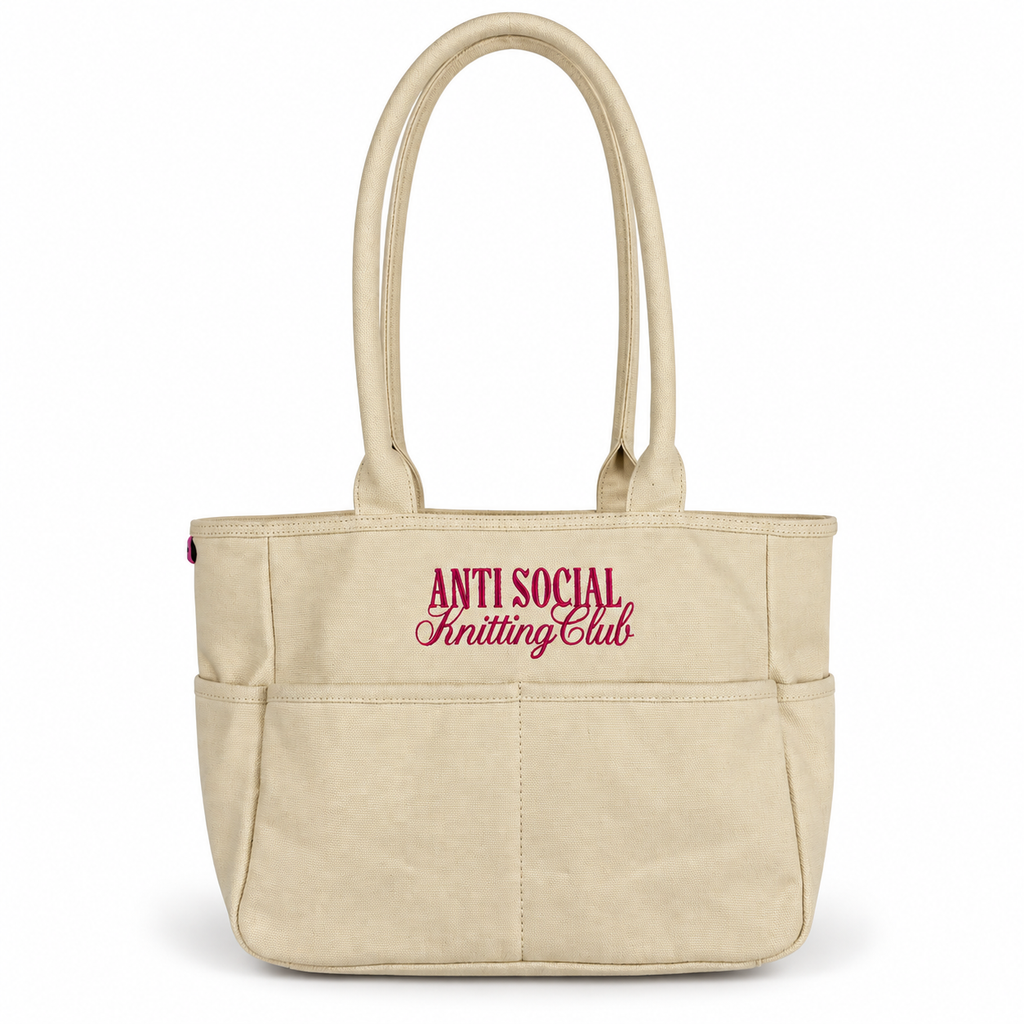 Canvas TIMI Tote with bright pink “Anti Social Knitting Club” embroidery.