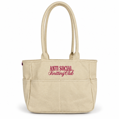 Canvas TIMI Tote with bright pink “Anti Social Knitting Club” embroidery.