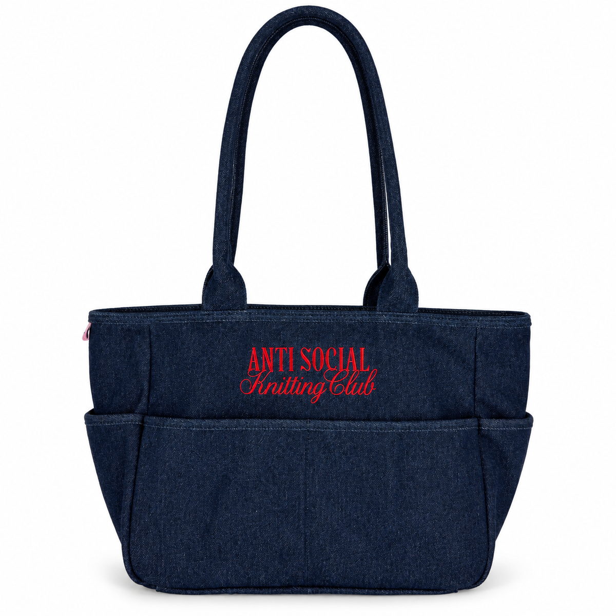 A dark navy blue denim tote bag with red embroidered text reading 'ANTI SOCIAL Knitting Club' on the front, set against a plain white background.