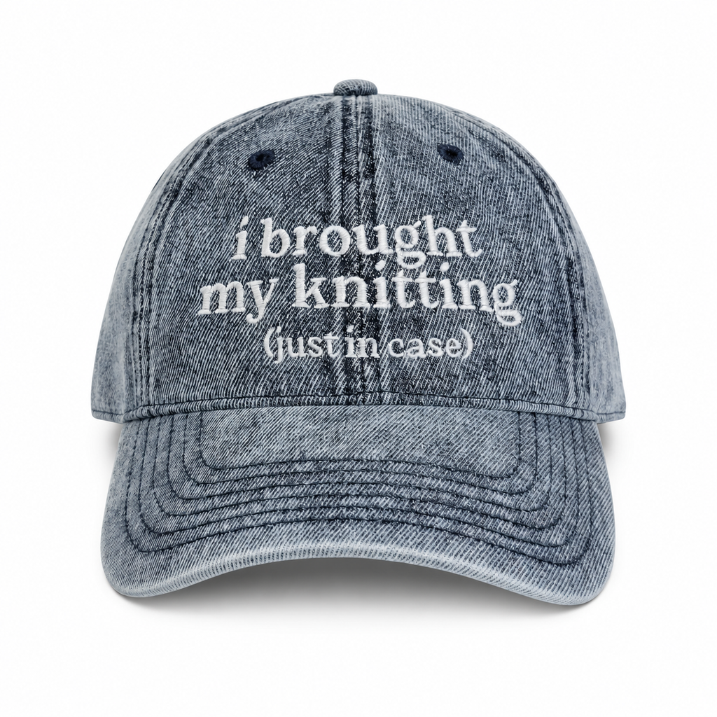 Blue denim cap with white text on a white background