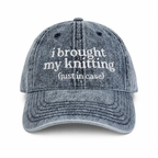 Blue denim cap with white text on a white background