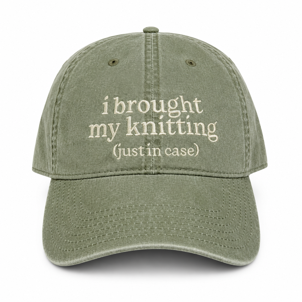 Green cap with text 'i brought my knitting (justin case)' on a white background