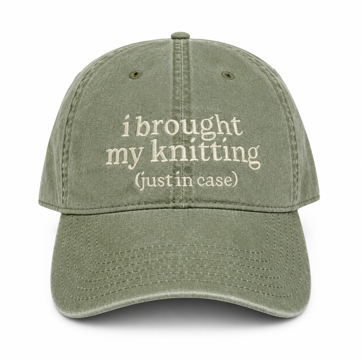 Green cap with text 'i brought my knitting (justin case)' on a white background