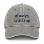 Gray cap with 'always knitting' text on a white background