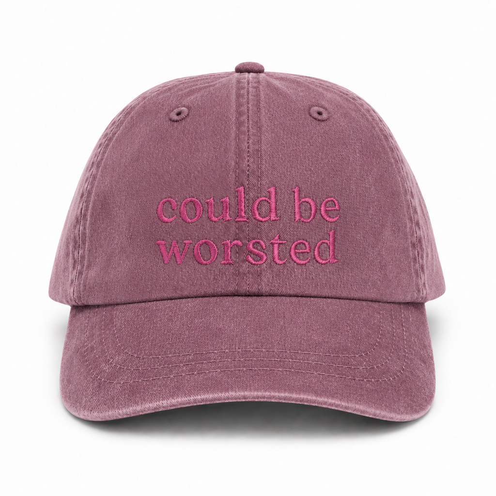 Mauve cap with 'could be worsted' text on a white background
