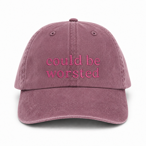 Mauve cap with 'could be worsted' text on a white background