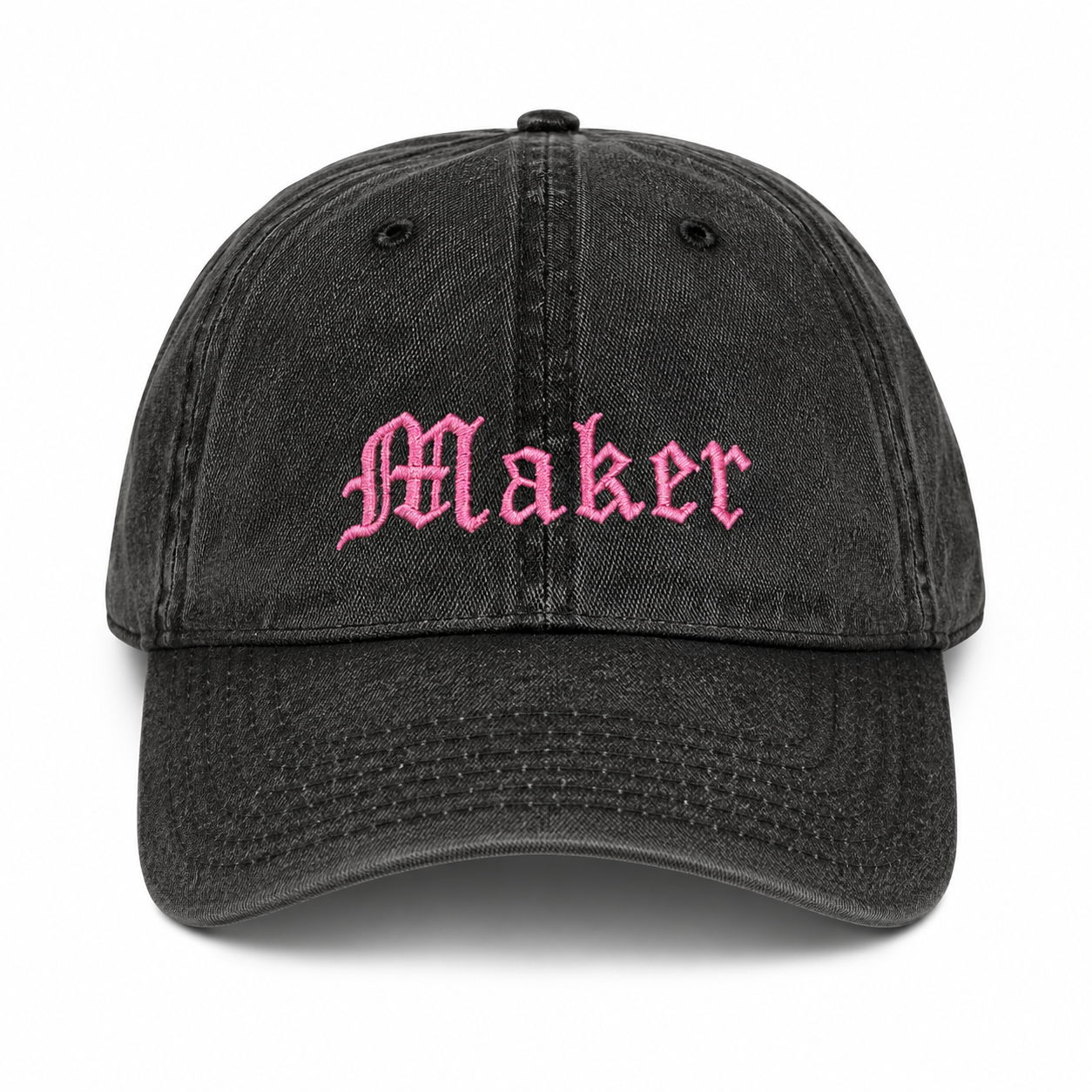 Black cap with 'Maker' embroidered in pink on a white background