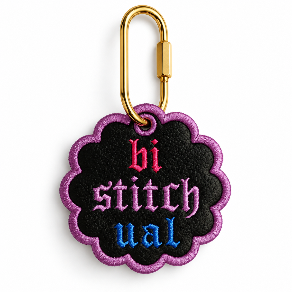 A scalloped black embroidered patch with a purple border and the word 'bi stitchual' in pink, purple, and blue gothic lettering, attached to a gold carabiner on a white background.