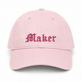 Pink cap with 'Maker' embroidered on a white background