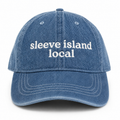 Blue denim cap with 'sleeve island local' text on a white background