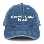 Blue denim cap with 'sleeve island local' text on a white background