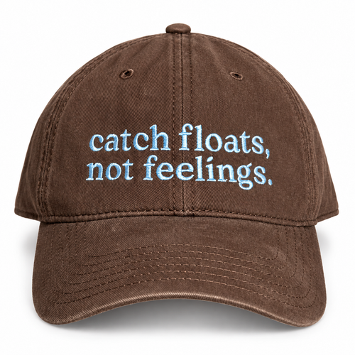 A brown washed cotton baseball cap with the phrase 'catch floats, not feelings.' embroidered in light blue on the front, shown against a plain white background.