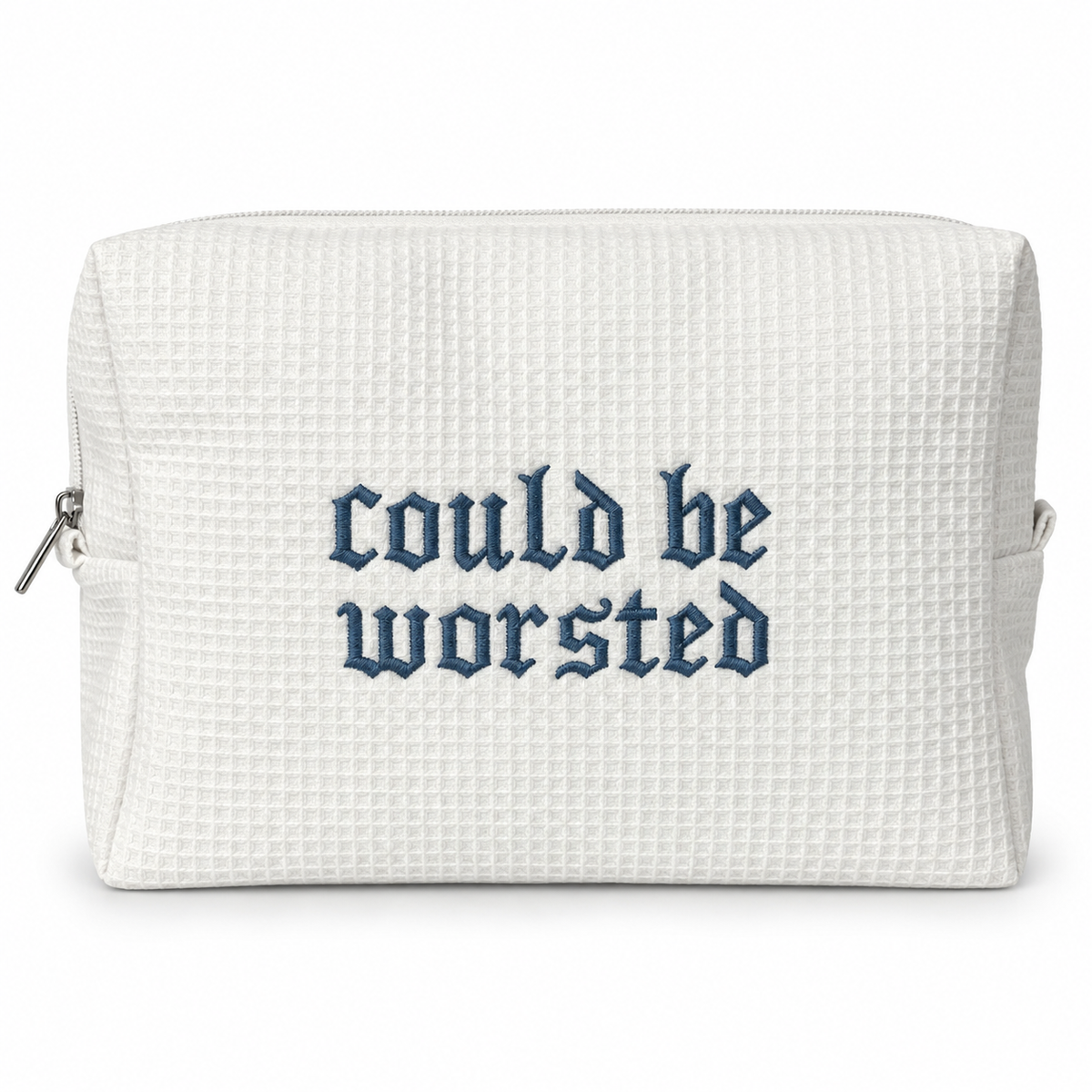 A white waffle-weave zippered pouch with the phrase 'could be worsted' embroidered in a dark blue Gothic font on the front, shown against a plain white background.