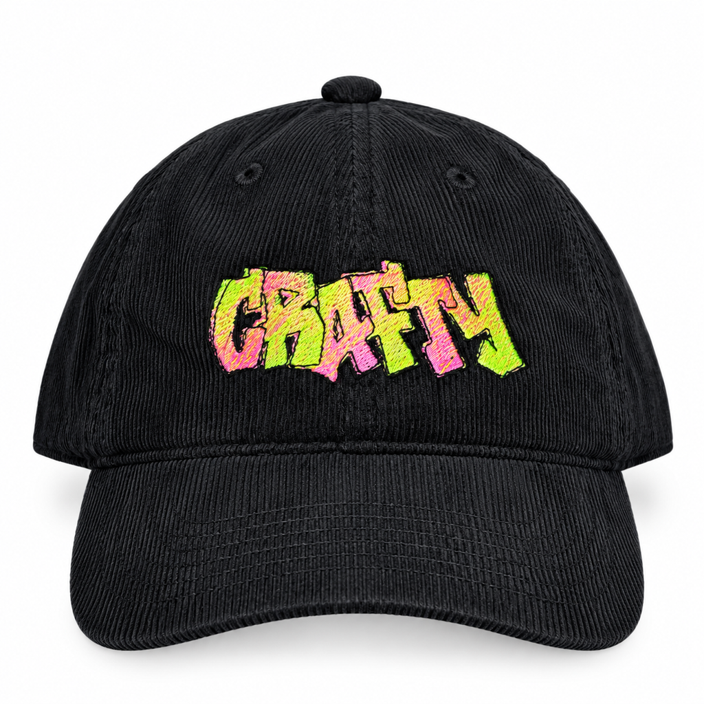 A black corduroy baseball cap featuring the word 'CRAFTY' embroidered across the front in a vibrant, multicolored graffiti-style font with pink, orange, yellow, and green hues, set against a plain white background.