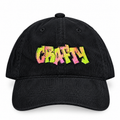 A black corduroy baseball cap featuring the word 'CRAFTY' embroidered across the front in a vibrant, multicolored graffiti-style font with pink, orange, yellow, and green hues, set against a plain white background.
