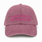 Pink cap with 'catch floats, not feelings' text on a white background