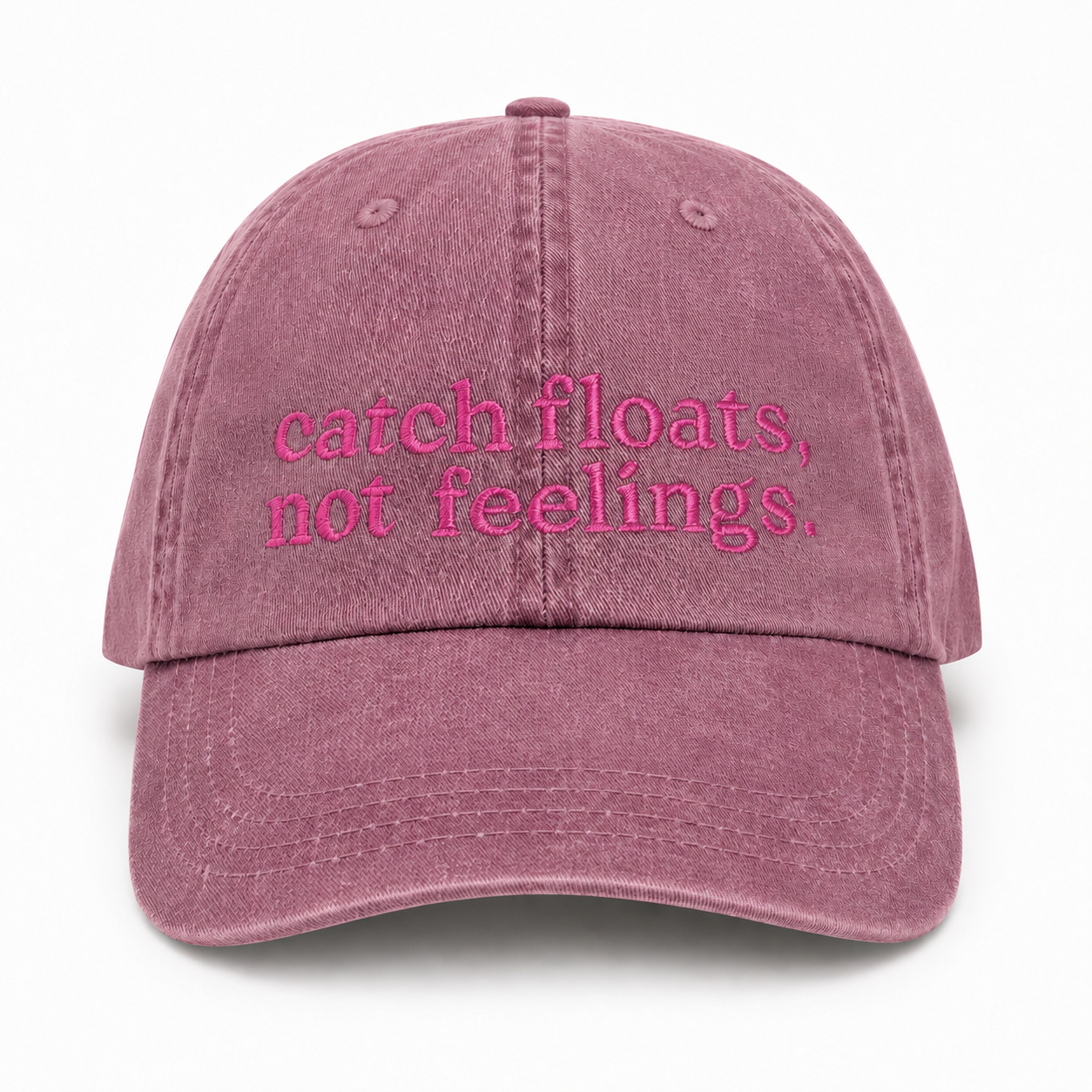 Pink cap with 'catch floats, not feelings' text on a white background