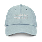 Light blue cap with ''could be worsted' ' text on a white background