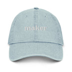 Light blue cap with 'maker' text on a white background