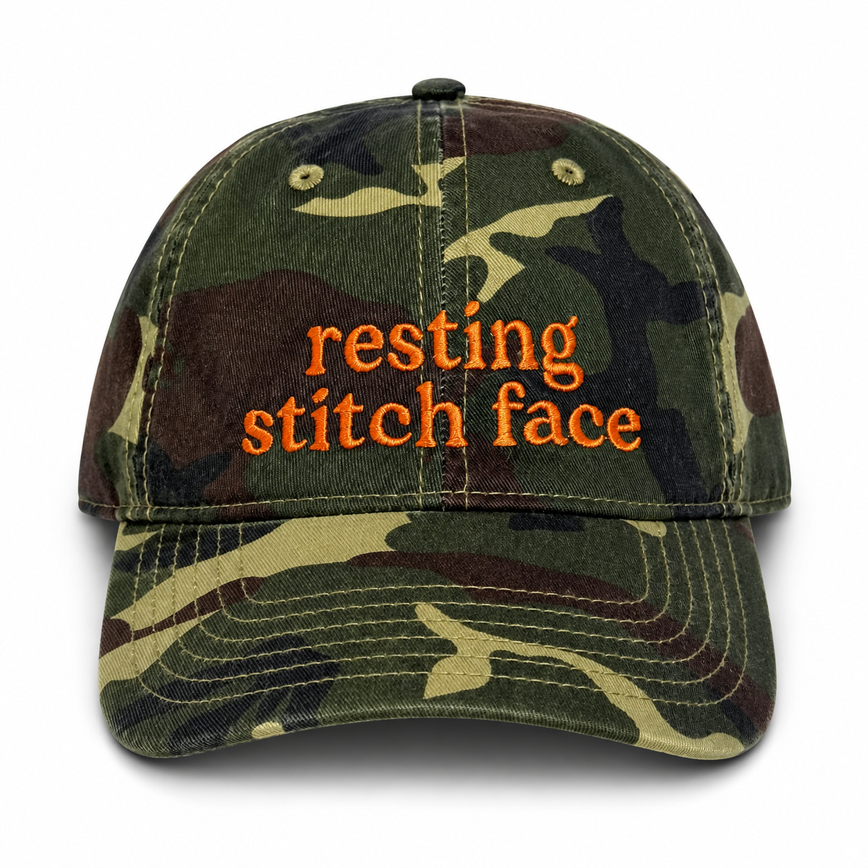 Camouflage cap with 'resting stitch face' text on a white background