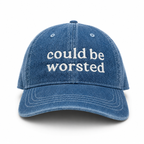 Blue denim cap with 'could be worsted' text on a white background