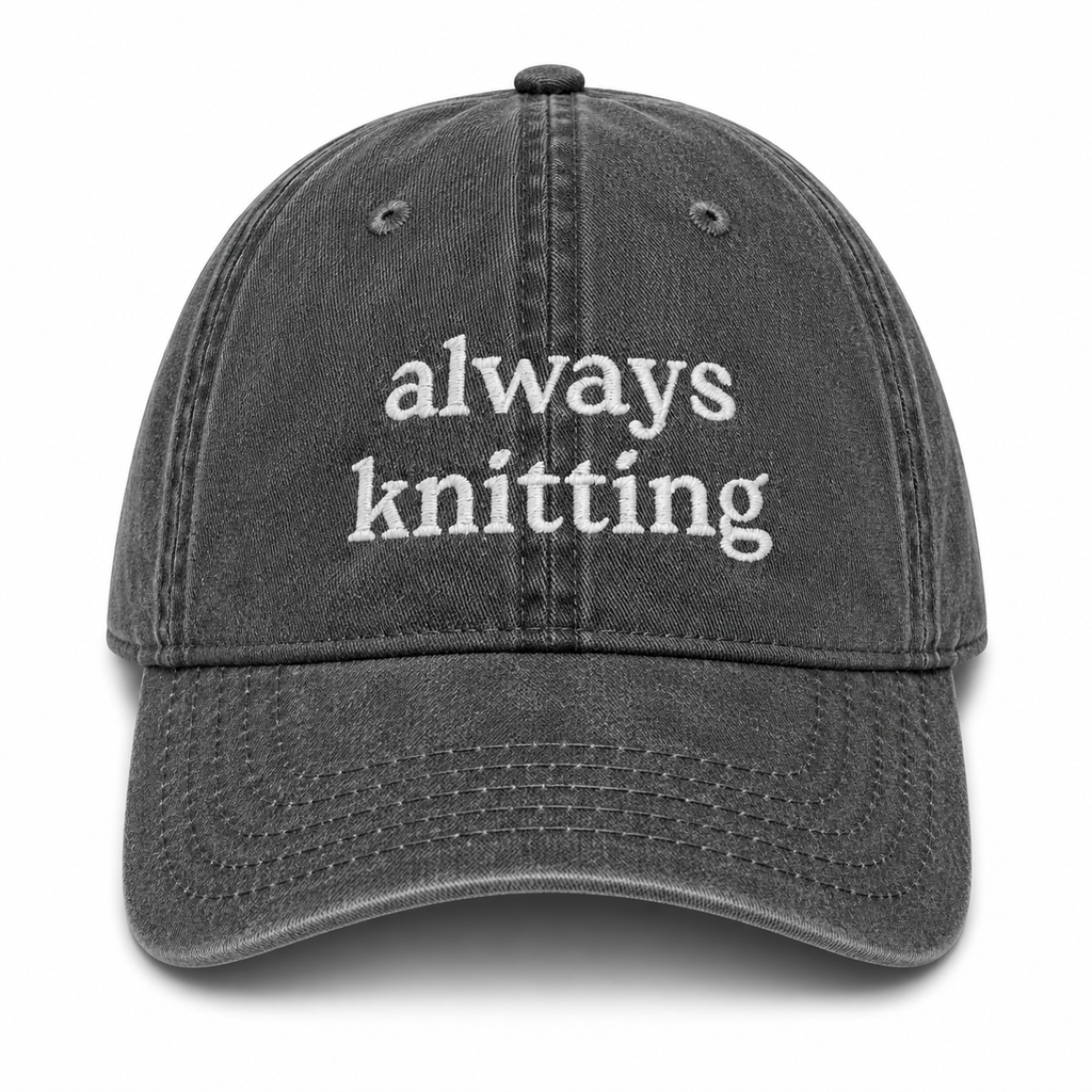 Gray cap with 'always knitting' text on a white background