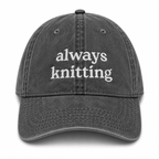 Gray cap with 'always knitting' text on a white background