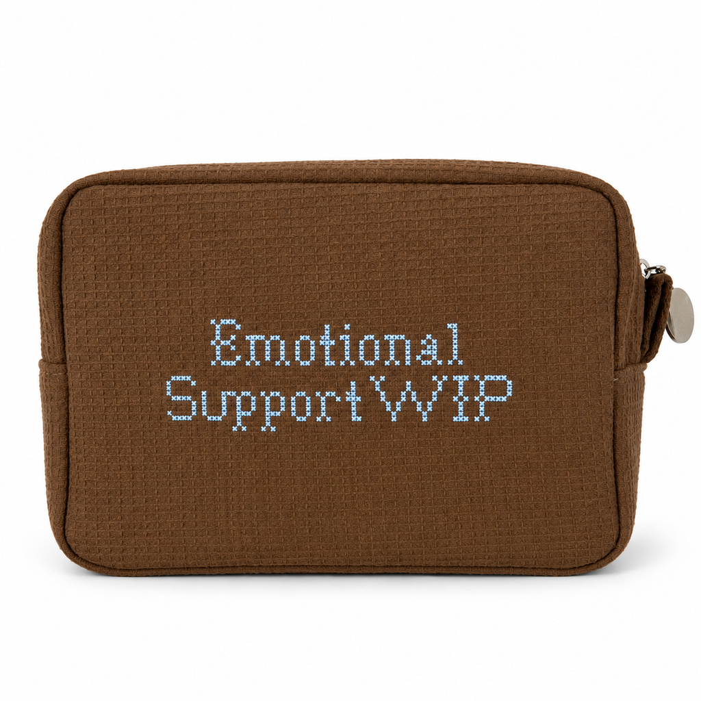 A brown woven fabric pouch with the words 'Emotional Support WIP' embroidered in light blue on the front, shown on a plain white background.