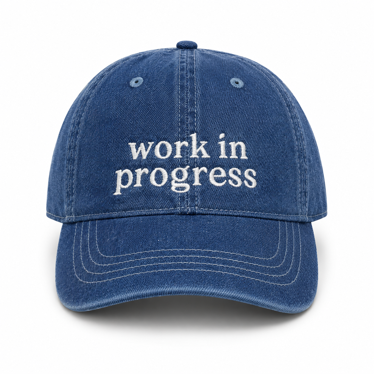 Blue cap with 'work in progress' text on a white background