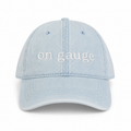 Light blue cap with 'on gauge' text on a white background