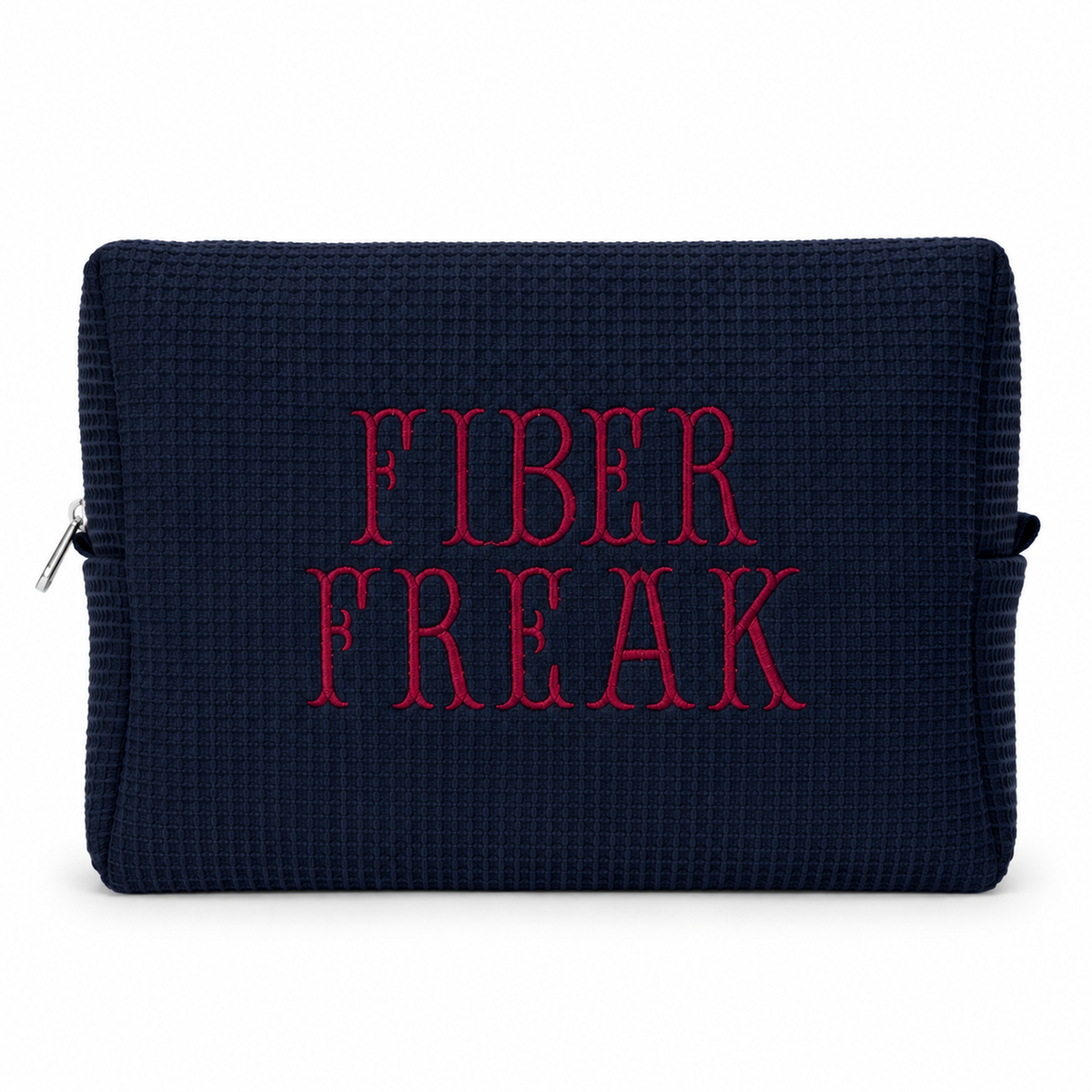 A dark navy blue textured pouch with the words 'FIBER FREAK' embroidered in red across the front, shown on a plain white background.