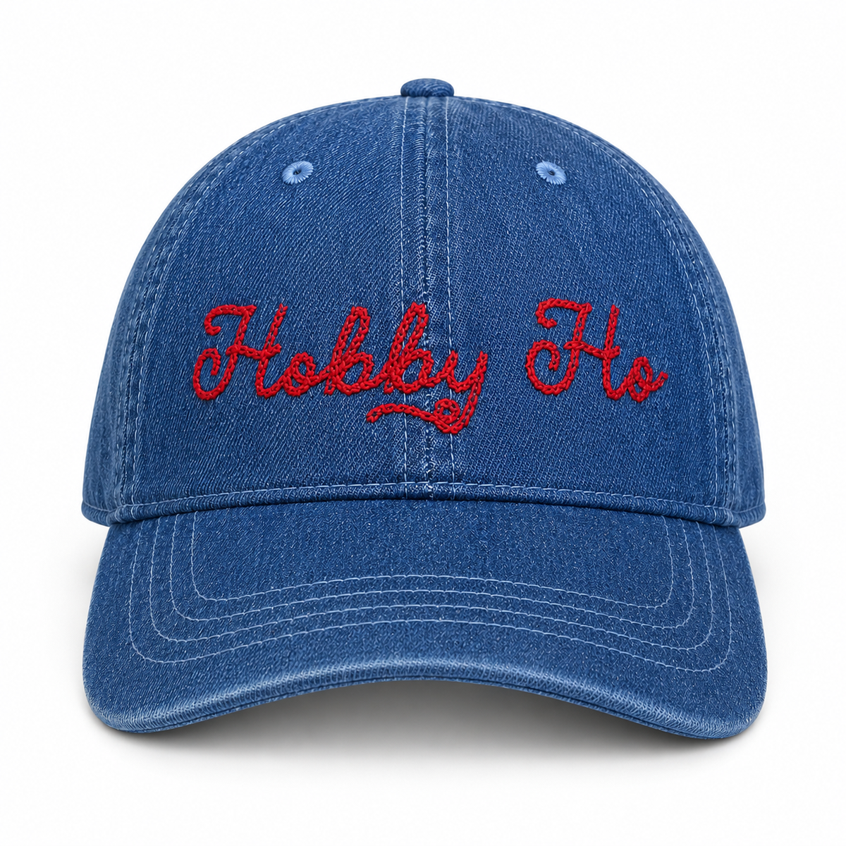 Medium denim dad hat with red chain stitch “Hobby Ho” embroidery.