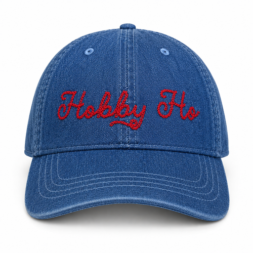 Medium denim dad hat with red chain stitch “Hobby Ho” embroidery.