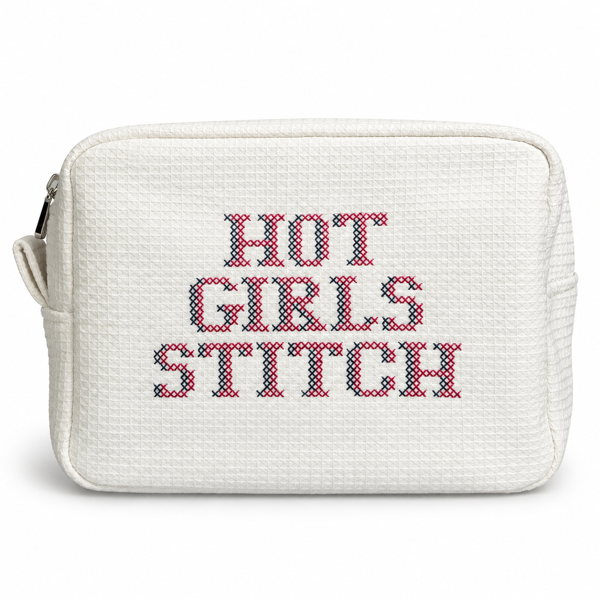 White waffle zip pouch with pink and slate blue “Hot Girls Stitch” cross stitch embroidery.