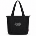 A black canvas tote bag with two shoulder straps, featuring the white printed text 'i brought my crochet (just in case)' on the front, set against a plain white background.