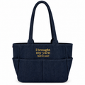 A navy blue fabric tote bag with two shoulder straps, front utility pockets, and yellow embroidered text reading 'i brought my yarn (just in case)'.