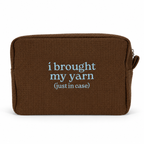 A brown textured zippered pouch with the phrase 'i brought my yarn (just in case)' printed in light blue text on the front, shown against a plain white background.