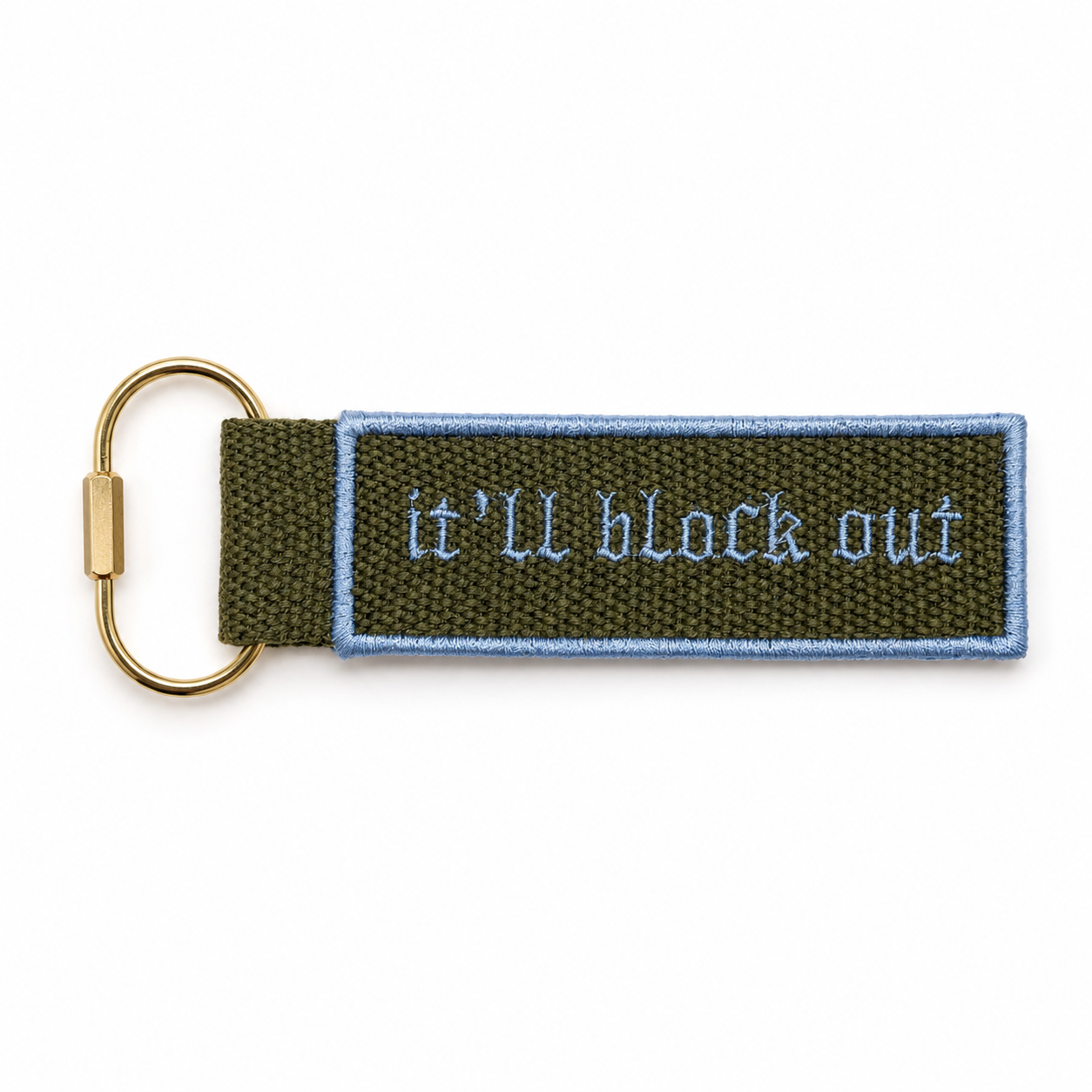 Olive green bag charm with baby blue It’ll Block Out embroidery and gold-tone key ring hardware
