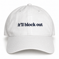 White dad hat with navy “It’ll Block Out” mini text embroidery.