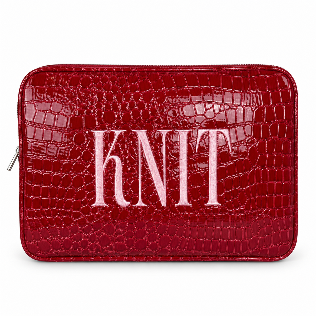 A red crocodile-embossed zippered pouch with the word 'KNIT' in large light pink letters across the front, shown on a plain white background.