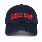 Navy distressed washed cotton hat with Knit Sox red puff embroidery and white embroidered detail